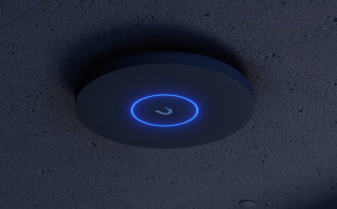 UniFi access point mounted on a concrete ceiling